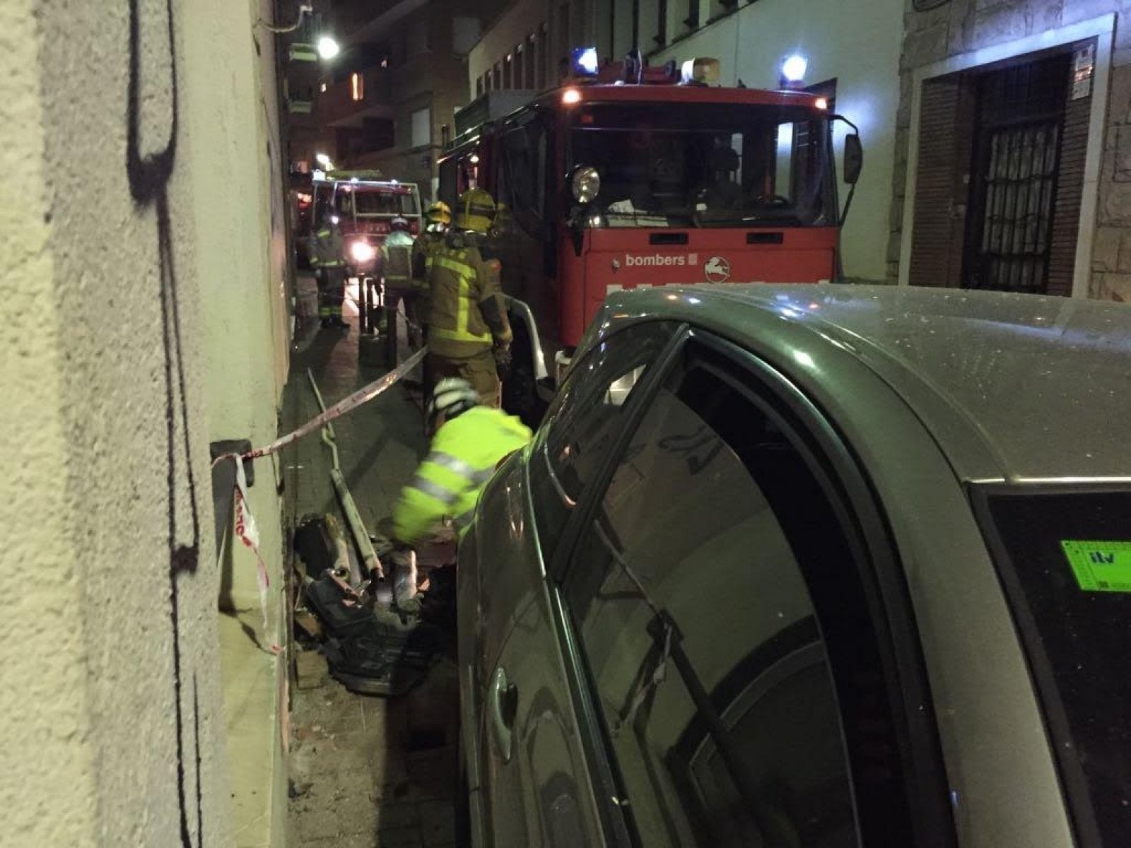 Bombers i operaris del gas treballant en l'accident