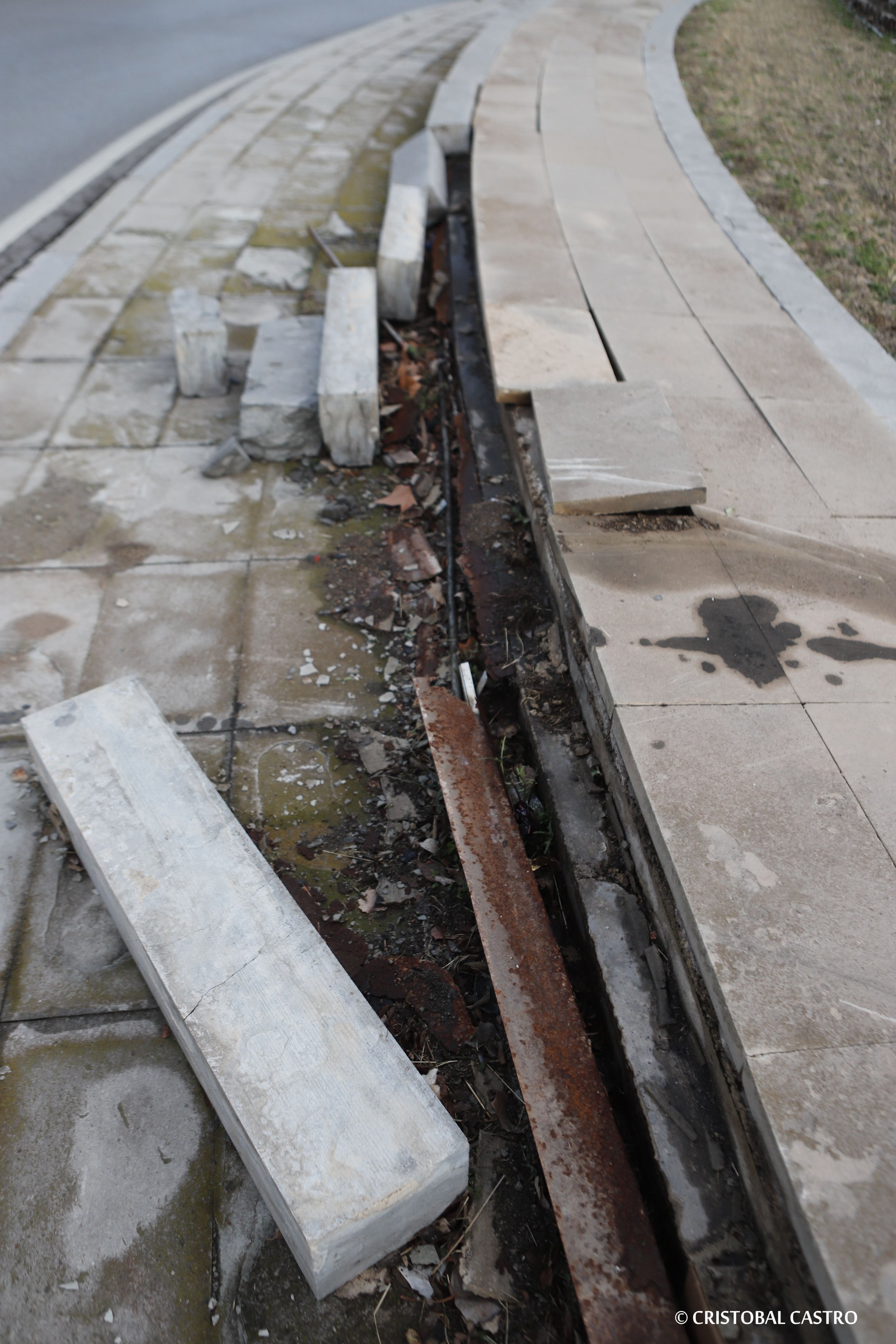 Estat en què es troba la plaça de la Dona Treballadora de Terrassa. L'incivisme i la falta de manteniment han deixat en un estat deplorable la rotonda i el monument. Les rajoles han anat desapareixent, els blocs de ciment han caigut, i els cables s'han despenjat. Ja no només és una qüestió estètica, sinó que representa un perill per a la seguretat dels vianants, i requereix una intervenció urgent, almenys de neteja i sanejament | Cristóbal Castro