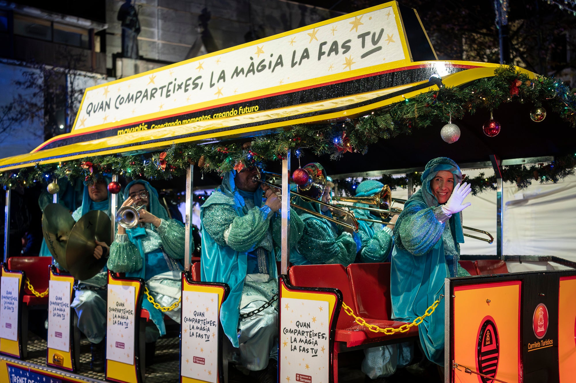 Malgrat unes condicions meteorològiques adverses, que han obligat a canviar l'itinerari de la corrua anant en trenet des de l'Estació del Nord i impedint que els Gegants de Terrassa poguessin acompanyar-lo baixant pel carrer de la Font Vella i es fes el Ball de l'Àliga al final, el patge Xiu-Xiu ha tingut la grata sorpresa a la seva arribada al Raval de Montserrat de trobar-se amb el seu capgròs com a regal pel seu 75 aniversari. Obra de l'artesà Jan Grau, el patge també compta a partir d'ara amb la seva figureta al pessebre oficial davant de l'Ajuntament. I des d'aquest dissabte i fins al 5 de gener, recorrerà els barris de la ciutat per recollir les cartes als Reis dels nens i nenes que s'hagin portat bé | Mireia Comas