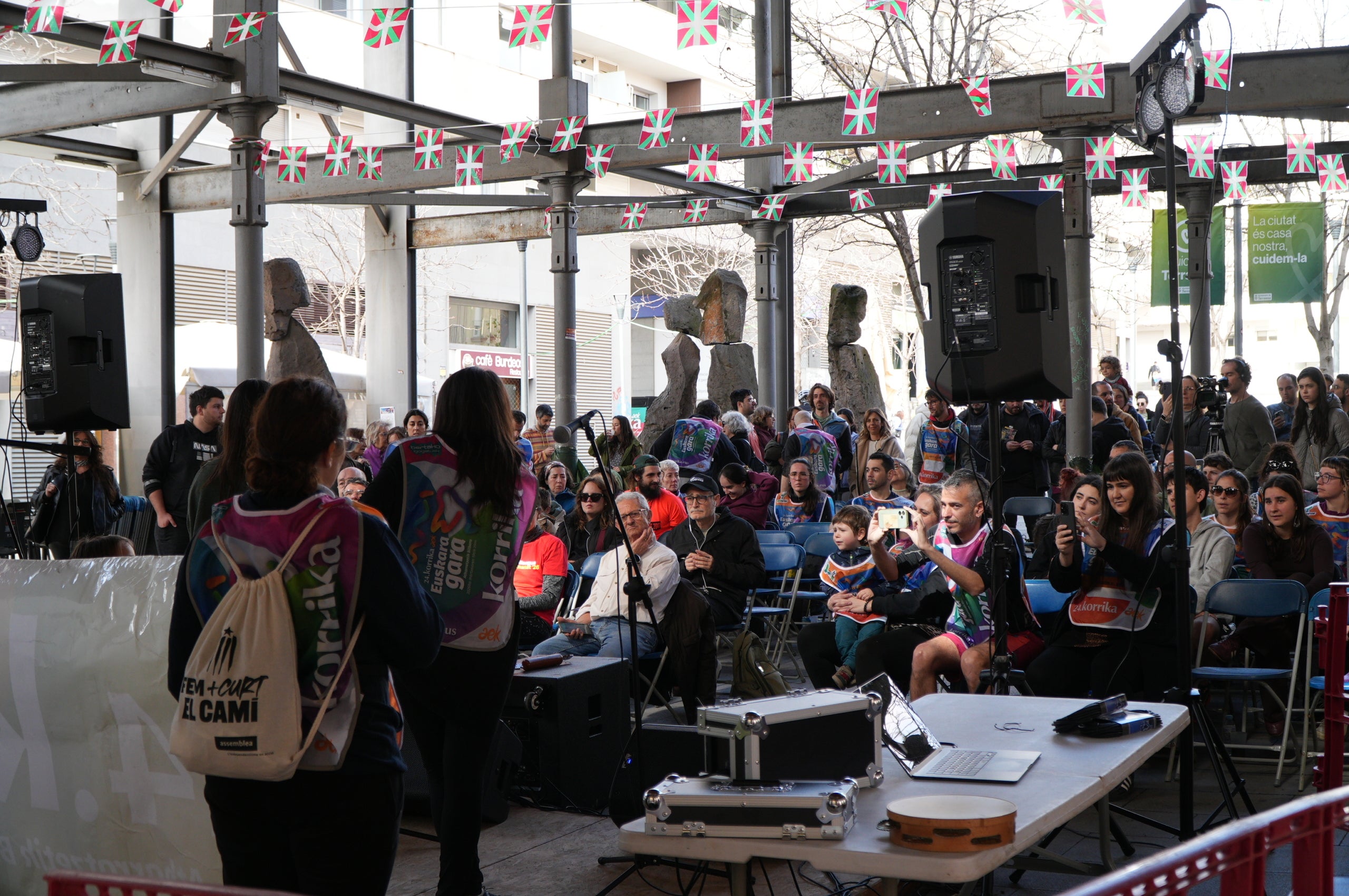La plaça del Vapor Ventalló i els seus voltants, al centre de Terrassa, van ser l'escenari aquest dissabte de la segona edició local de la Korrika, una cursa que es fa cada dos anys al País Basc des del 1980 per reivindicar l'ús de l'euskera. I que, en la versió terrassenca, s'estén a l'ús del català i altres llengües minoritzades. Al matí, grups de totes les edats van córrer per aquests cèntrics carrers abans que al migdia hi hagués un acte polític amb la participació d'integrants de l'AEK, coordinadora per a alfabetitzar i euskaldunitzar a la població. I també de membres de la Plataforma per la Llengua, Català a Terrassa, Òmnium Cultural, Correllengua i el moviment feminista de la ciutat. I, a partir d'aquí i amb interpretació de cançons tradicionals basques, va ser el torn per a un pintxo pote, un dinar amb paella, el concert d'Uralita i una fi de festa de ball | Jan Romero