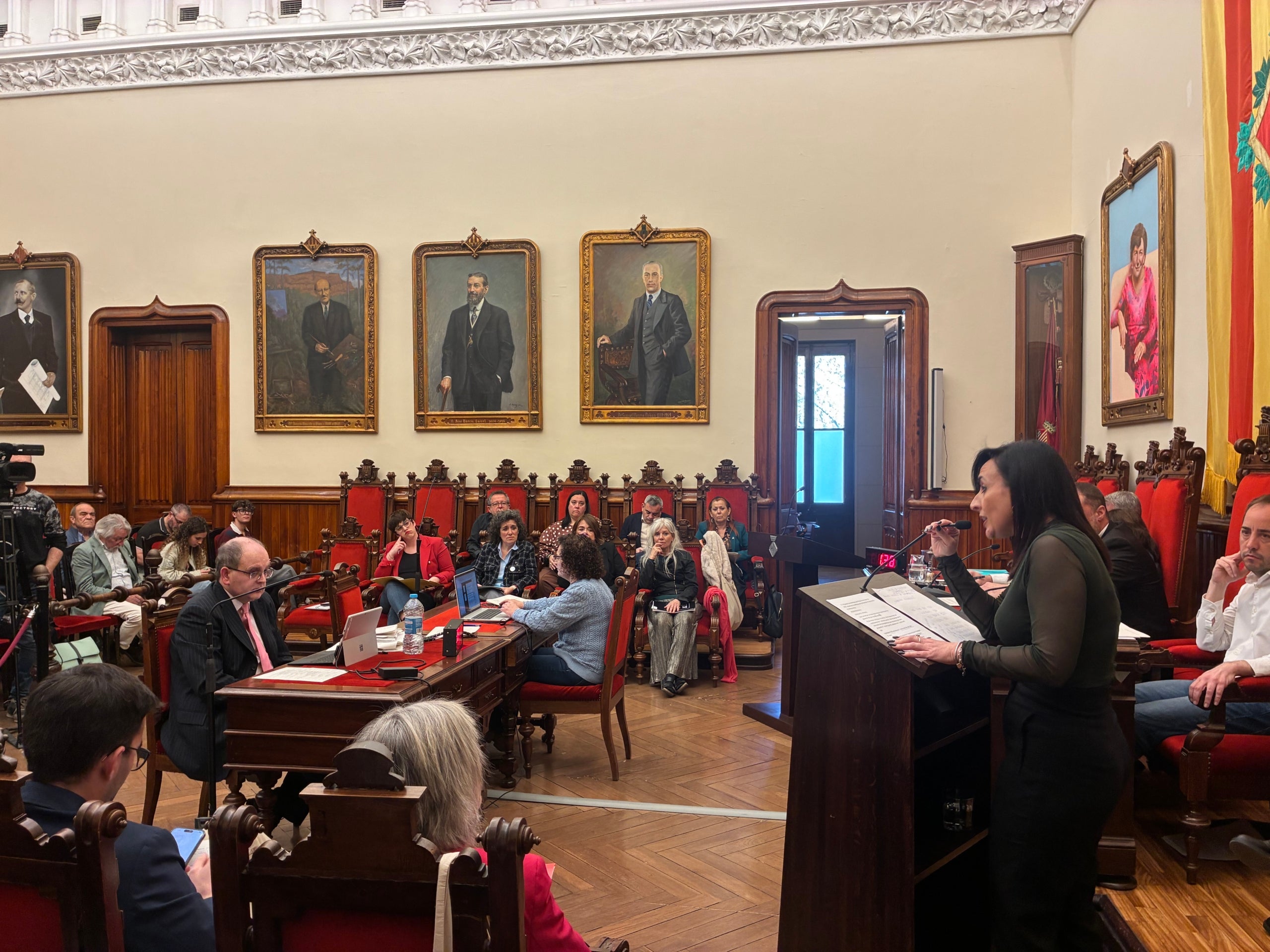 La cap de Vox a Terrassa, Alicia Tomás, intervenint al ple de març d'aquest divendres i el secretari municipal, Óscar González, escoltant a la taula d'enmig | Vicenç Batalla